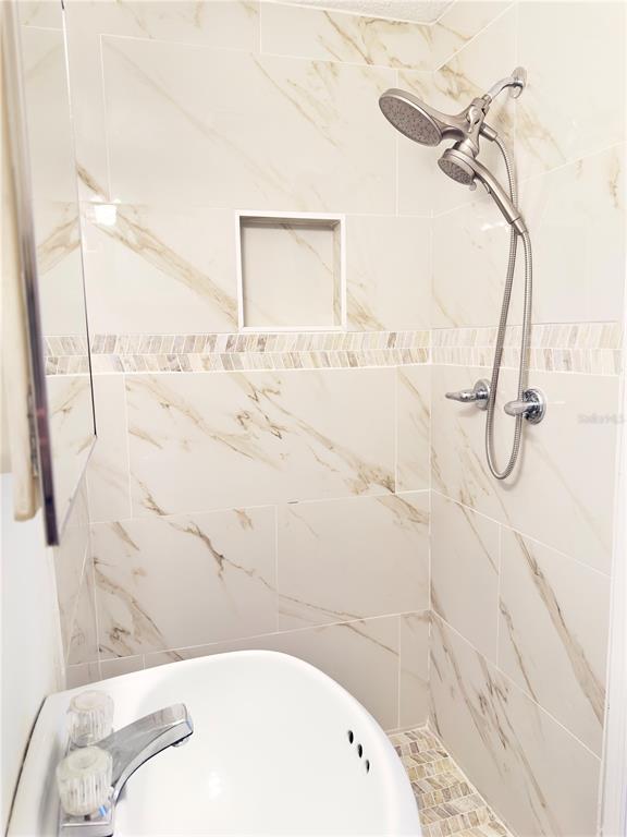 5701 Quist Drive Port Richey, FL 34668 - Photo 42 of 53 a bathroom with a bathtub and shower