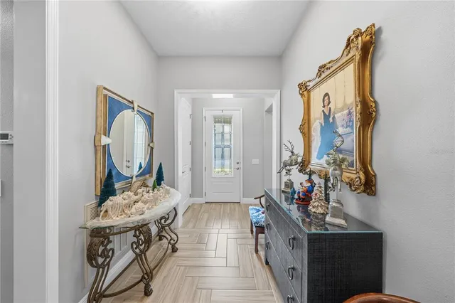 a front view of a house with a yard and potted plants