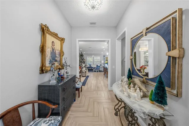 a front view of a house with a yard and potted plants