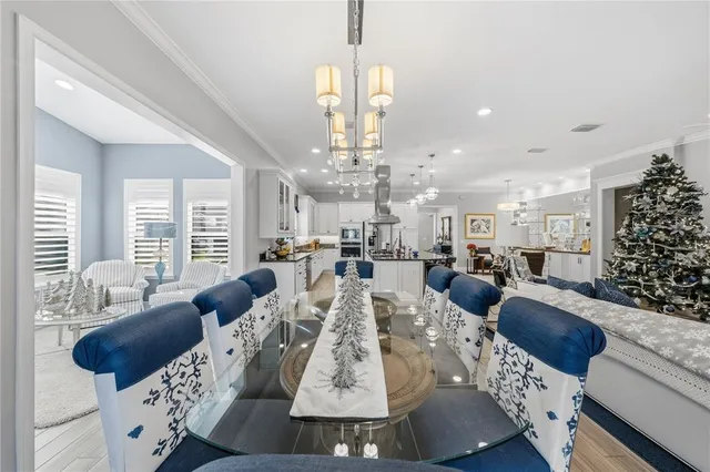 a view of a dining room with furniture large windows and wooden floor