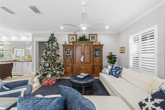 a kitchen with stainless steel appliances kitchen island granite countertop a table chairs and a refrigerator