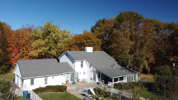 a view of a house with a yard