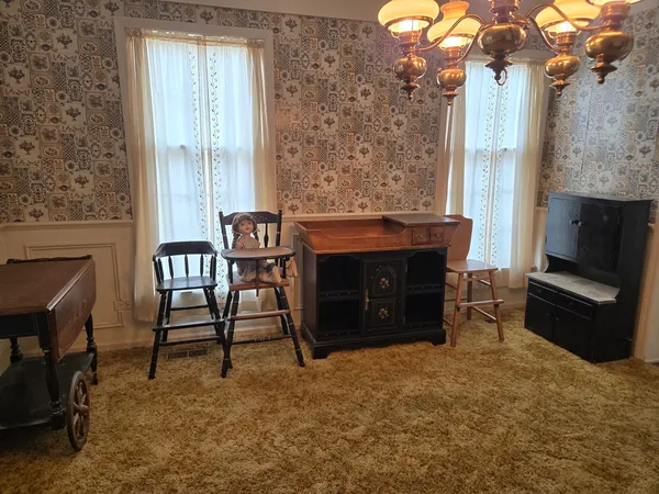 a view of a dining room with furniture and chandelier