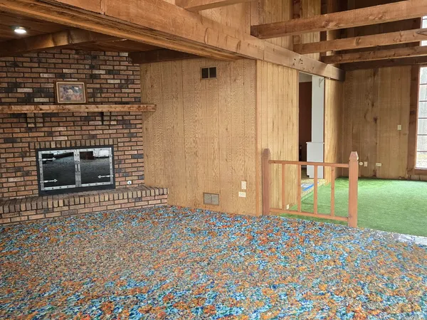 an empty room with wooden floor and cabinet