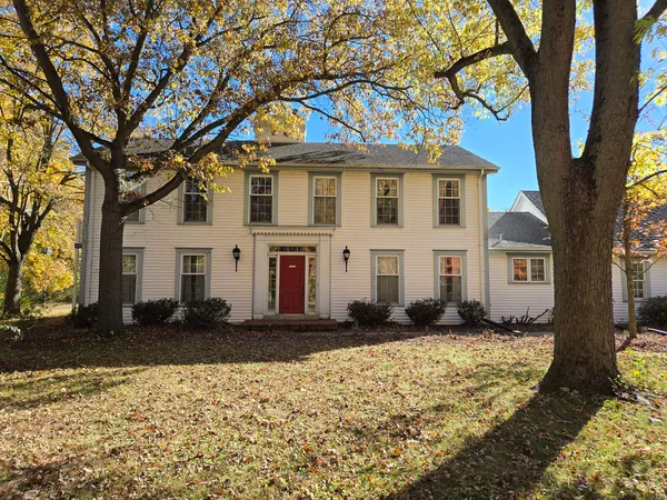 a house that has a tree in front of the house