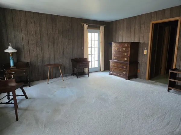 an empty room with windows and closet area
