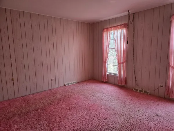 a room with cabinet and a window
