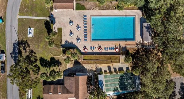 a backyard of a house with fountain table and chairs