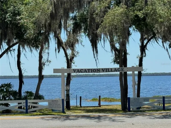 a front view of a house with garden and plants