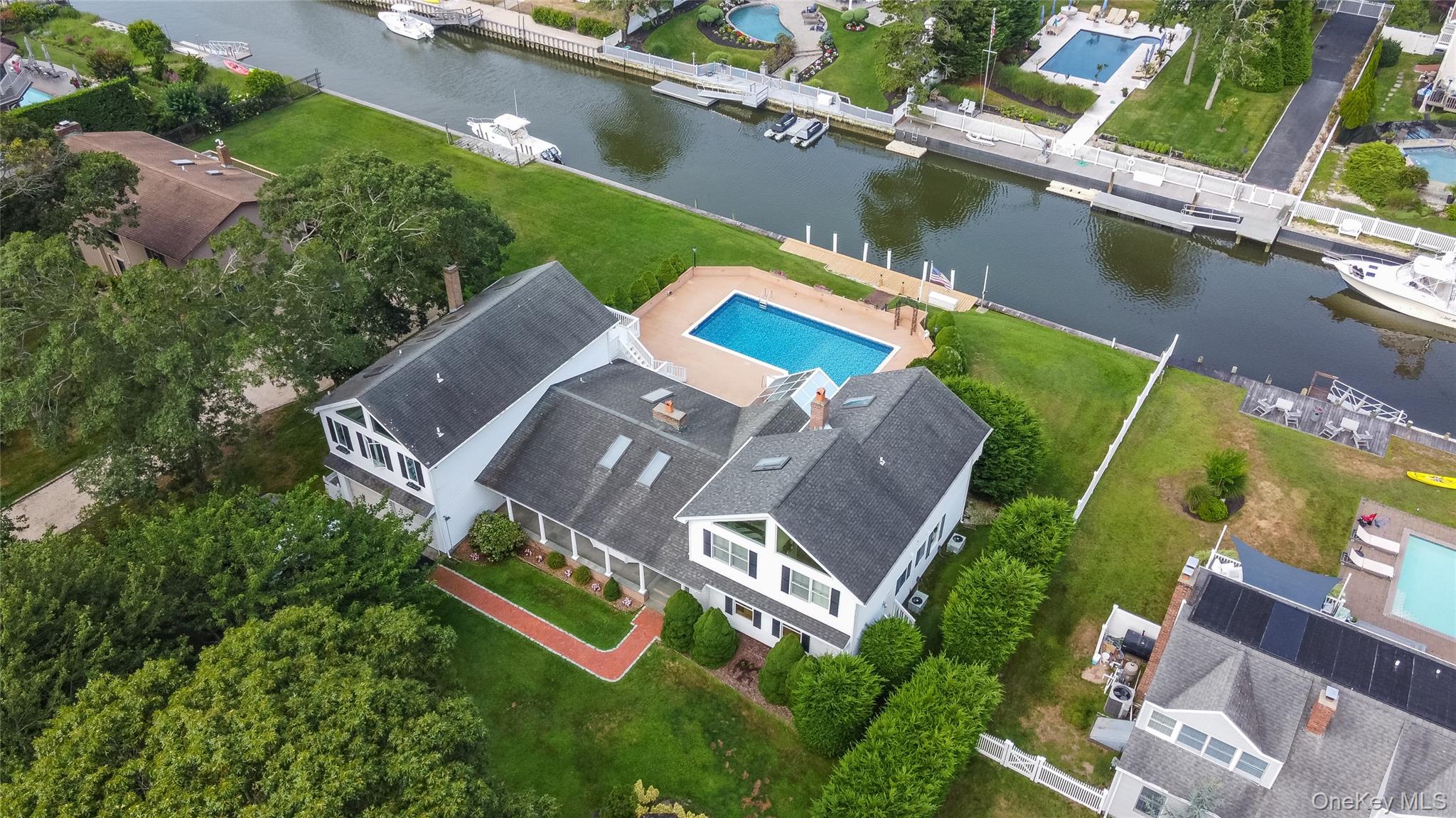 an aerial view of a house with a garden and swimming pool