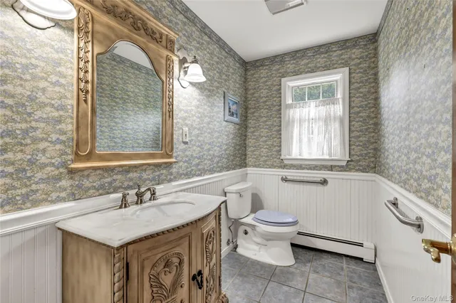 a bathroom with a granite countertop sink a toilet and bathtub