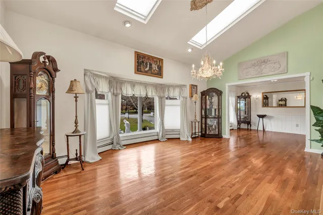 a view of a big room with wooden floor fan and windows