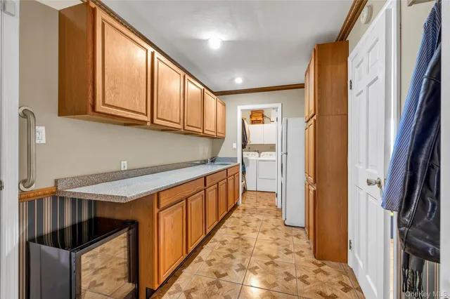 a kitchen with granite countertop white cabinets and white appliances