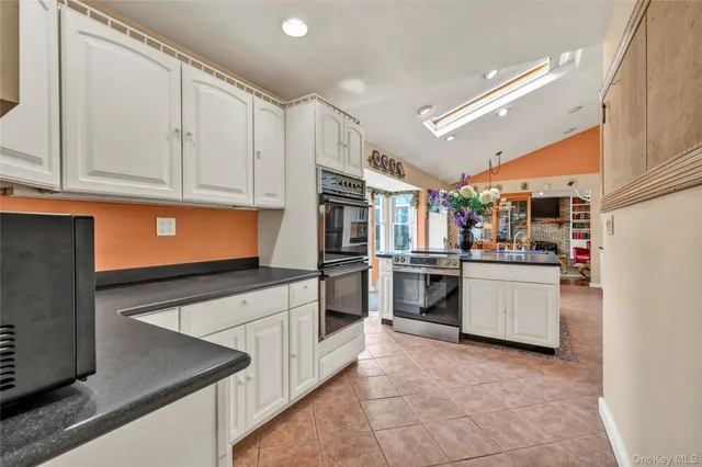 a kitchen with granite countertop a sink and stainless steel appliances