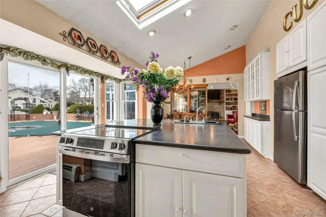 a dining room with furniture a flat screen tv and a large window