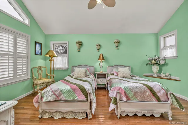 a bedroom with a bed and a large window with the outer view