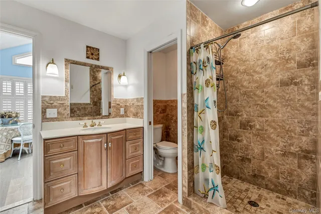 a bedroom with a large bed and wooden floor