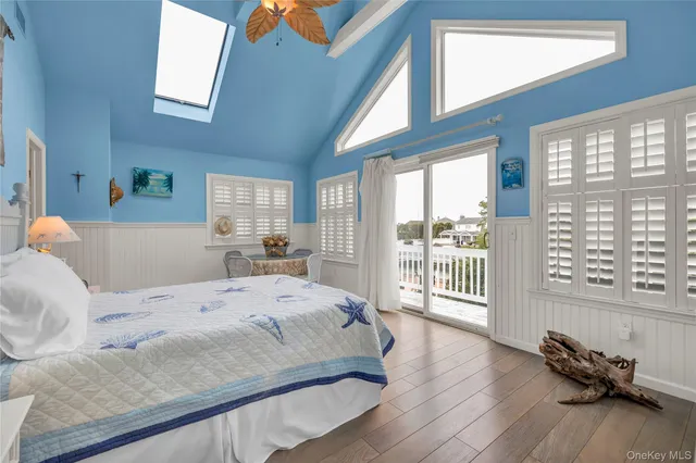 a bedroom with furniture and a wooden floor