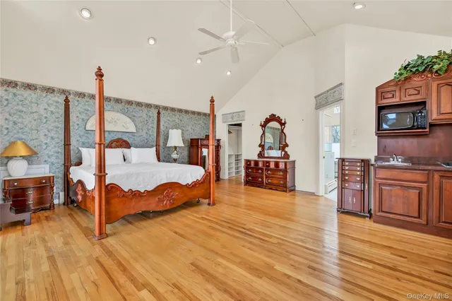 a view of hallway with stairs and wooden floor