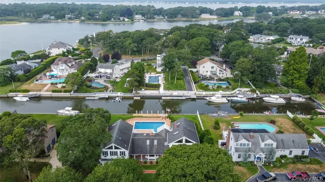 a view of house with swimming pool and yard in the background
