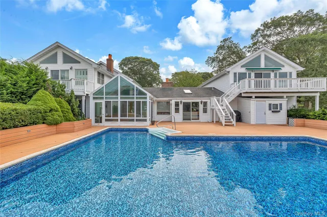 an aerial view of a house with a garden and trees