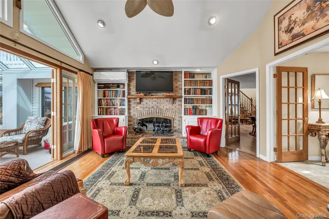 a living room with furniture a flat screen tv and a fireplace