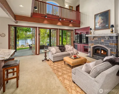 a living room with furniture a fireplace and a large window