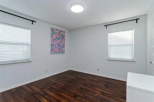 a view of a room with wooden floor and windows