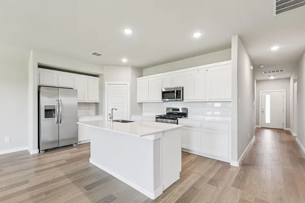 a living room with furniture and kitchen view