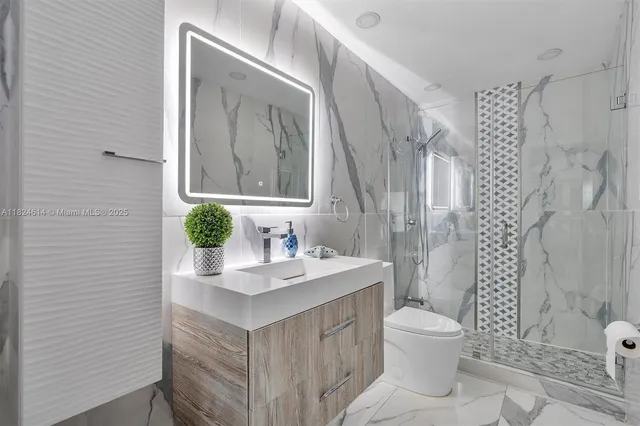 a bathroom with a sink toilet and shower