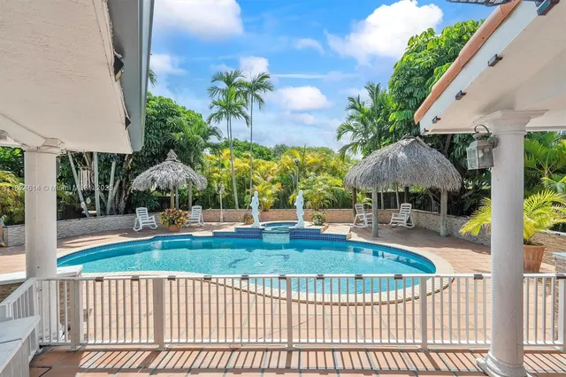 a view of swimming pool with an outdoor seating