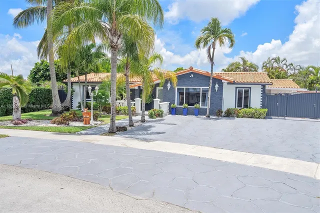 an aerial view of a house with a yard patio and lake view