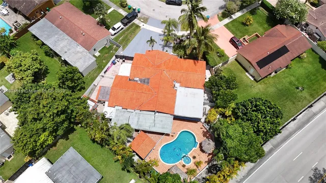 an aerial view of residential houses with outdoor space and street view