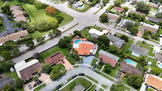 an aerial view of residential houses with outdoor space and lake view