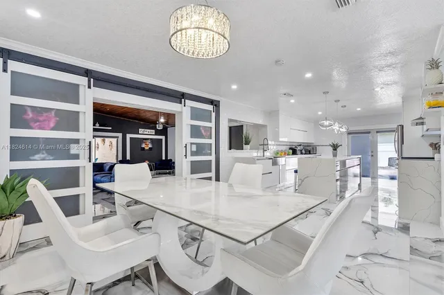 a large kitchen with a table and chairs