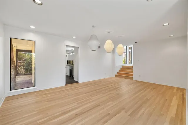 a view of a room with wooden floor and window