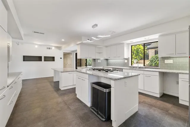 a kitchen with white cabinets and white appliances