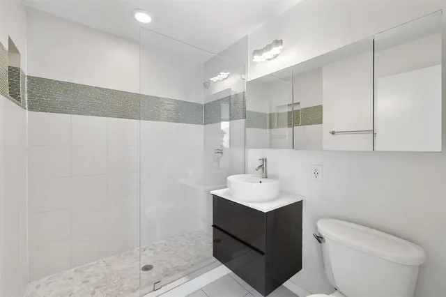 a bathroom with a sink toilet and shower