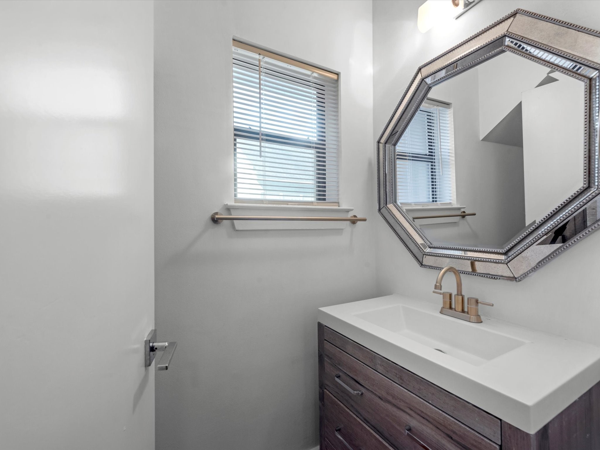 4421 Eigel Street Houston, TX 77007 - Photo 11 of 22 a bathroom with a sink a mirror and window