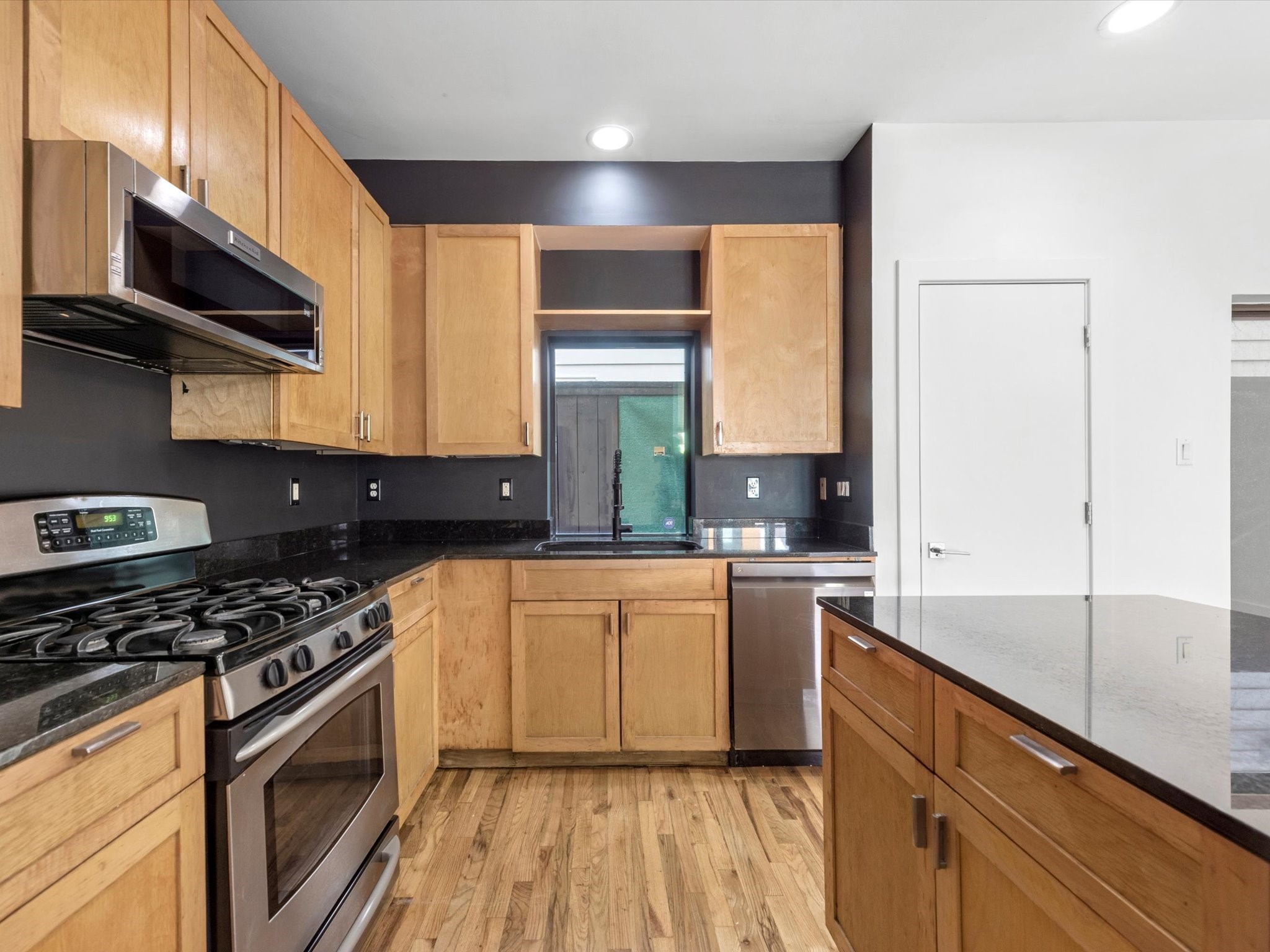 4421 Eigel Street Houston, TX 77007 - Photo 6 of 22 a kitchen with stainless steel appliances a sink stove and white cabinets
