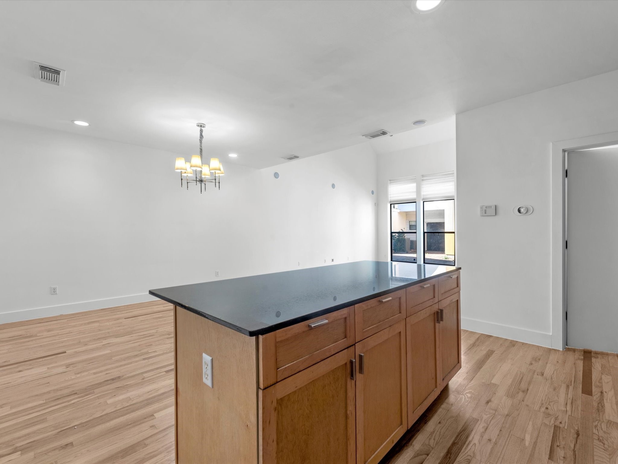 4421 Eigel Street Houston, TX 77007 - Photo 8 of 22 a kitchen with kitchen island granite countertop wooden floor a refrigerator and a sink