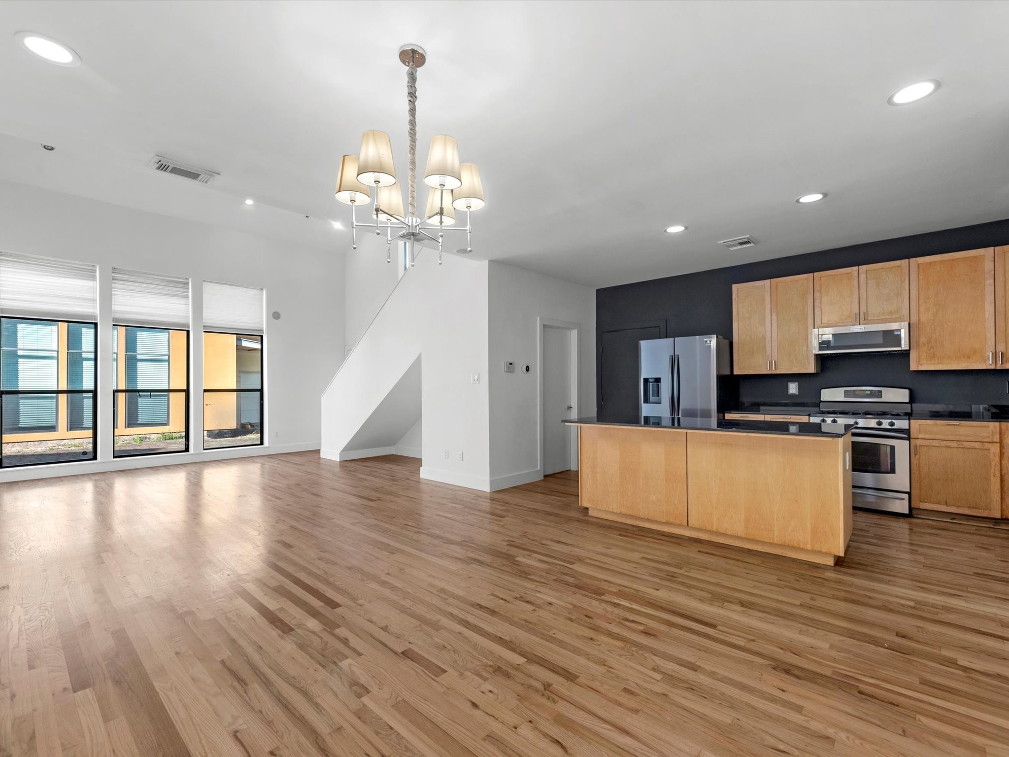 4421 Eigel Street Houston, TX 77007 - Photo 10 of 22 a open kitchen with stainless steel appliances granite countertop a dishwasher a stove and a wooden floor