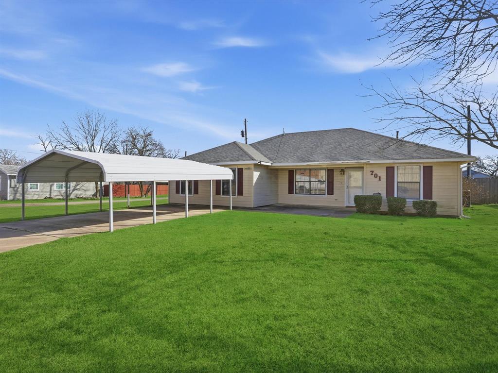 701 College Street Celeste, TX 75423 - Photo 2 of 29 a front view of a house with a garden