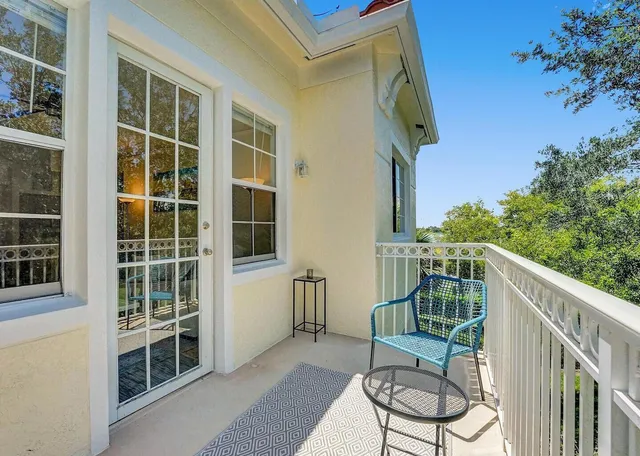 a balcony with table and chairs