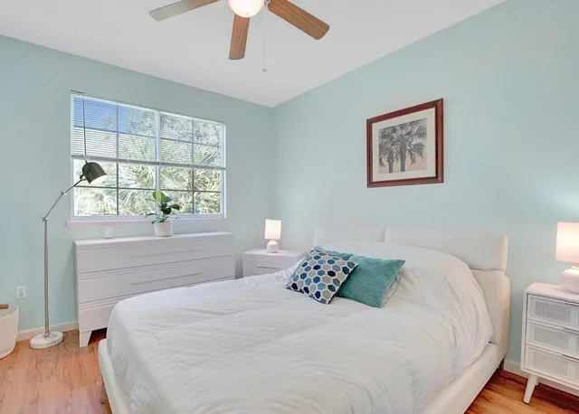 a bedroom with a large bed and a window