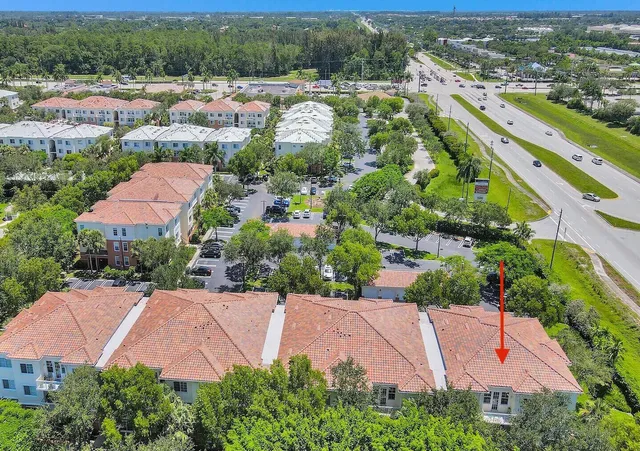 an aerial view of residential houses with outdoor space and street view