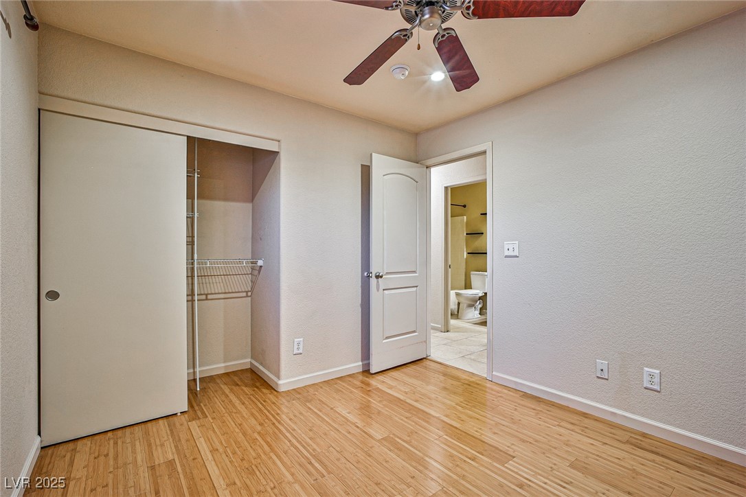 5128 Fall Meadows Avenue Las Vegas, NV 89130 - Photo 23 of 34 Unfurnished bedroom with light wood finished floors, a textured wall, a closet, and a ceiling fan