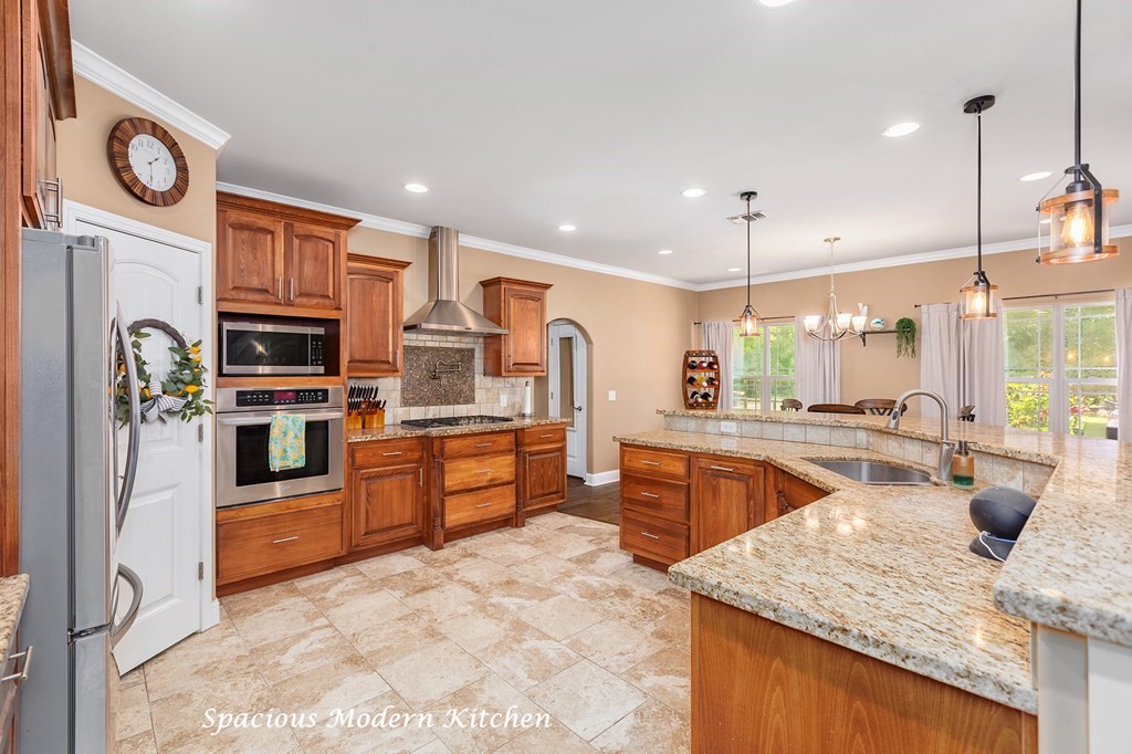 1171 Old Ewing Road Lufkin, TX 75901 - Photo 8 of 49 a kitchen with stainless steel appliances granite countertop a sink a stove and a refrigerator