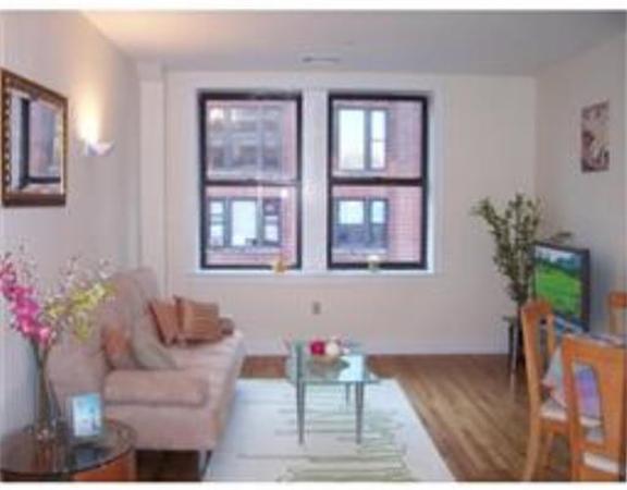 42 Beach Street, Unit 8A Boston, MA 02111 - Photo 1 of 1 a living room with furniture and flowers
