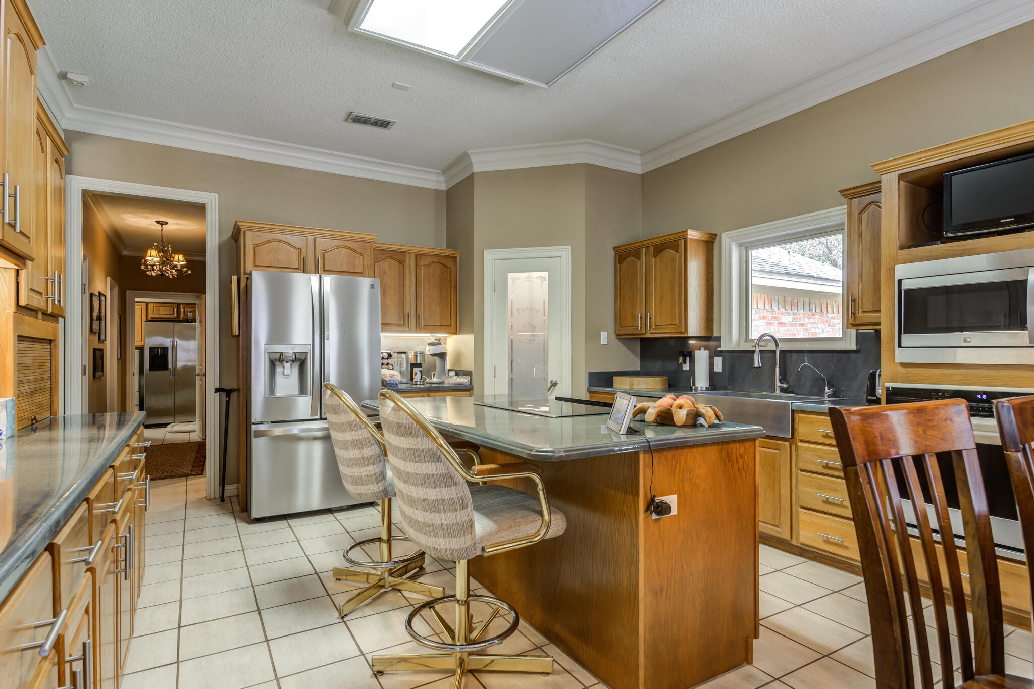 30 West Lakeshore Drive Ransom Canyon, TX 79366 - Photo 19 of 58 a view of a kitchen with kitchen island granite countertop a table and chairs